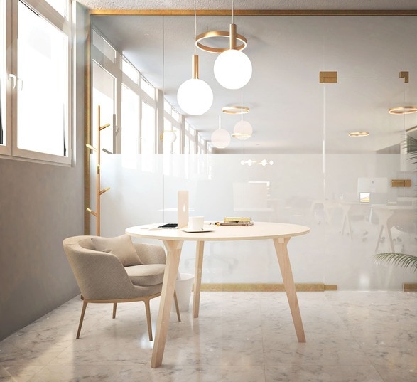 une grande plante verte, un siège gris et une table de réunion ronde dans une salle de réunion contemporaine